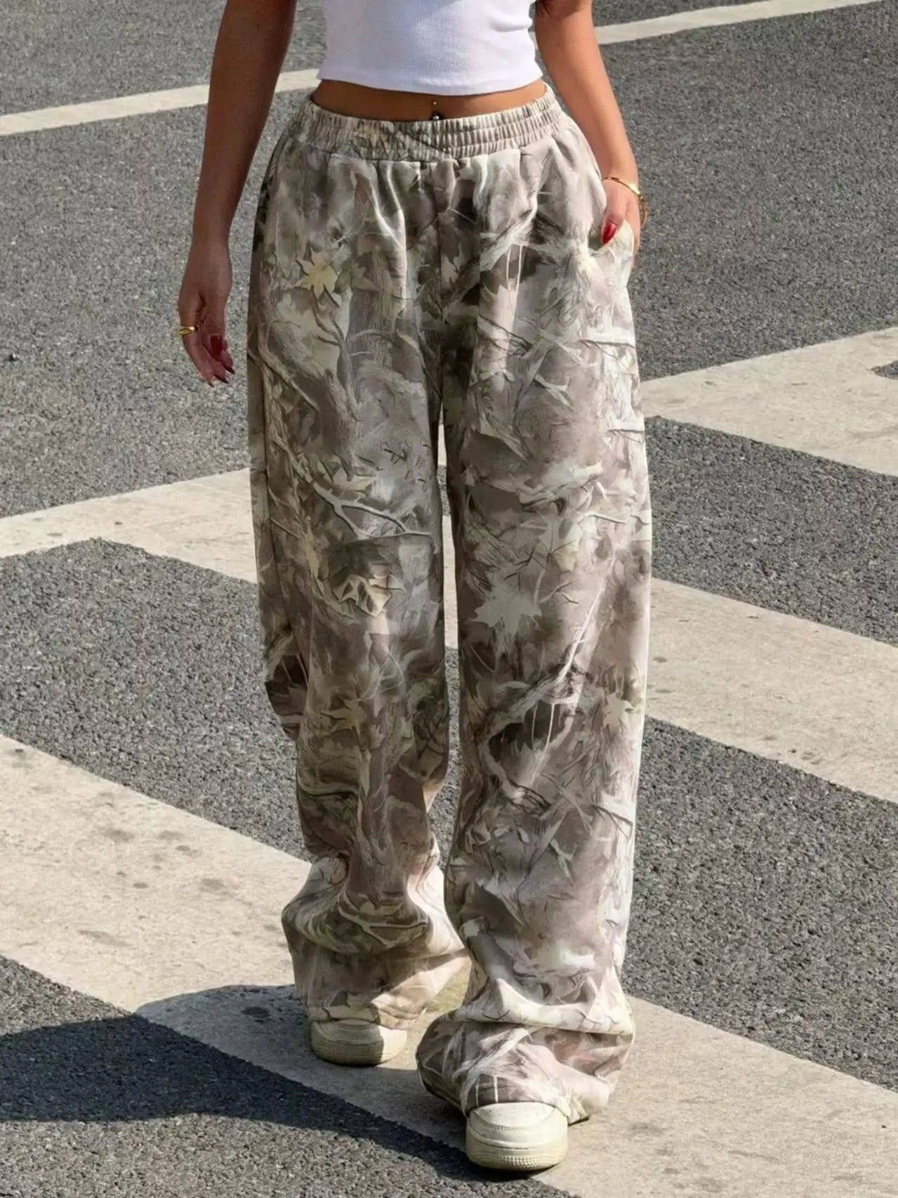 Fashionable casual pants with elastic waists and camouflage pri...